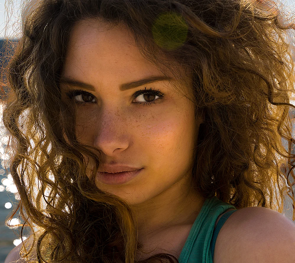 Ethnic rhinoplasty: Close-up of a female patient with natural nasal contours in outdoor light